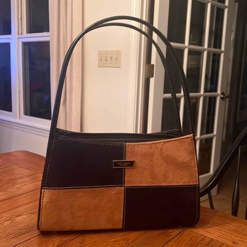 Nice bag. Suede black and tan. Never carried.